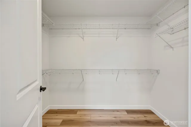 a spacious bathroom with a sink a mirror and a shower