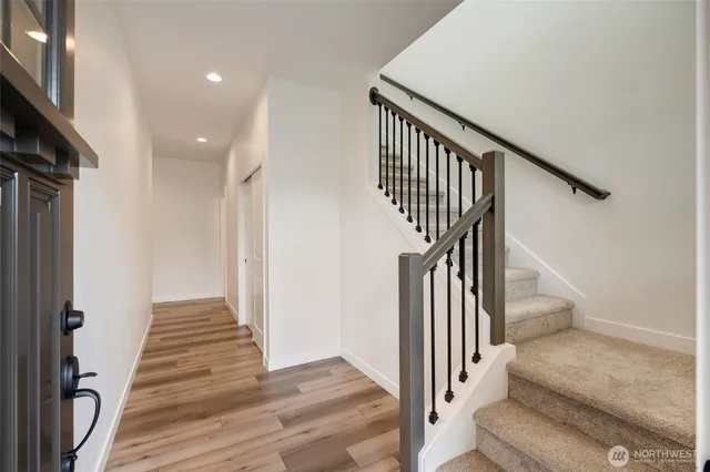 a view of entryway and hall with wooden floor