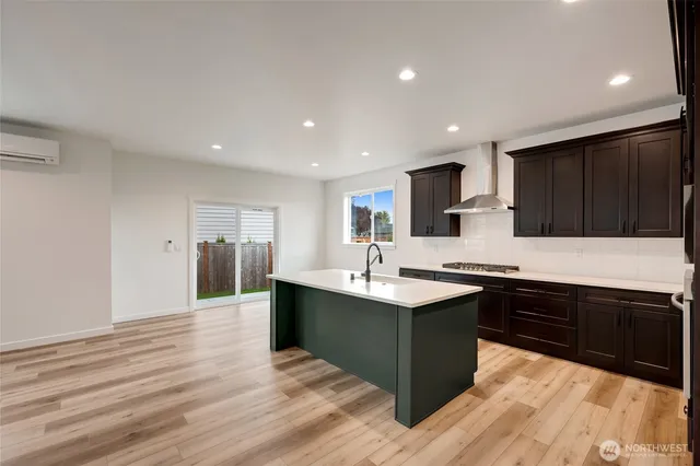 a kitchen with stainless steel appliances granite countertop a sink and cabinets