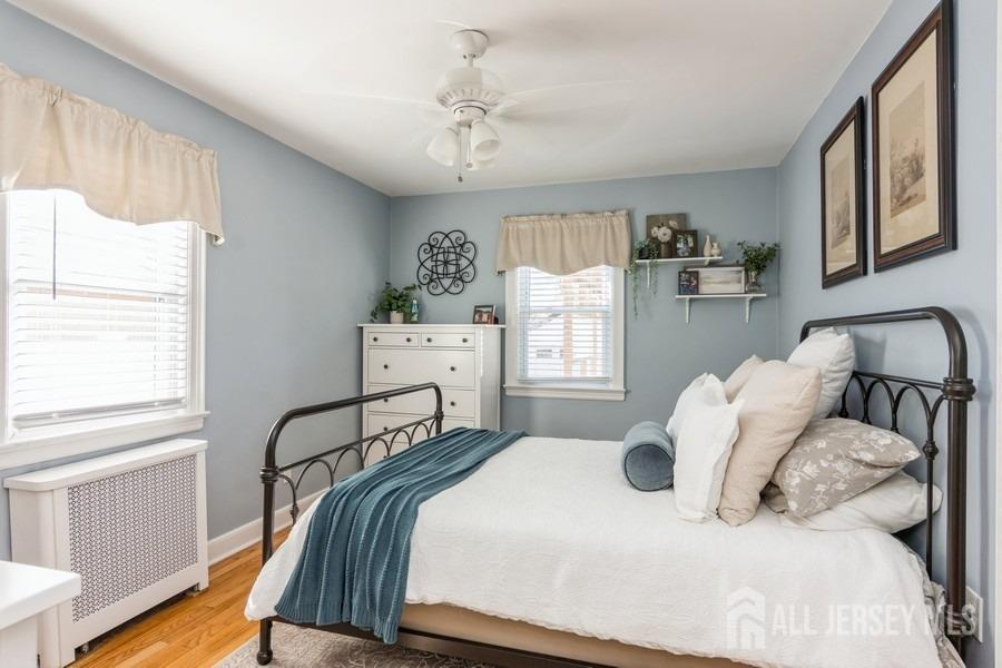 115 Midfield Road Colonia, NJ 07067 - Photo 11 of 25 a bedroom with a bed and wooden floor
