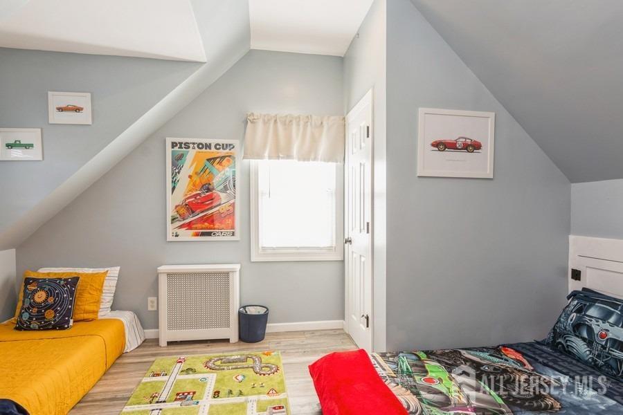 115 Midfield Road Colonia, NJ 07067 - Photo 14 of 25 a bedroom with a bed and wooden floor