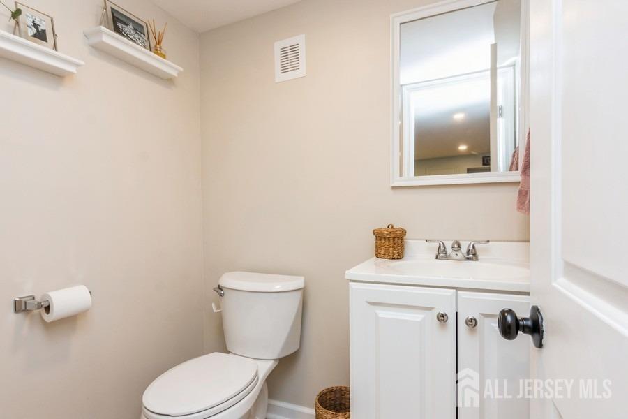 115 Midfield Road Colonia, NJ 07067 - Photo 20 of 25 a bathroom with a toilet sink and mirror