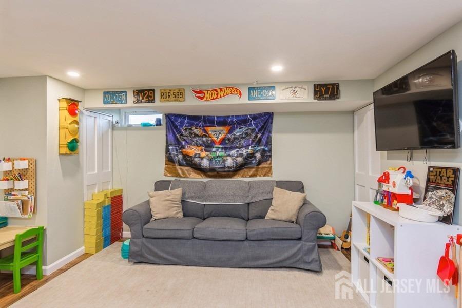115 Midfield Road Colonia, NJ 07067 - Photo 21 of 25 a living room with furniture and a flat screen tv