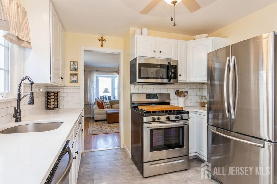 115 Midfield Road Colonia, NJ 07067 - Photo 7 of 25 a kitchen with granite countertop a refrigerator stove and sink