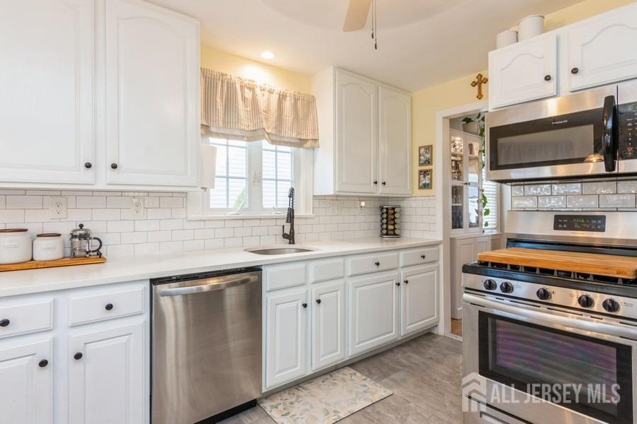 115 Midfield Road Colonia, NJ 07067 - Photo 9 of 25 a kitchen with granite countertop a sink cabinets and stainless steel appliances