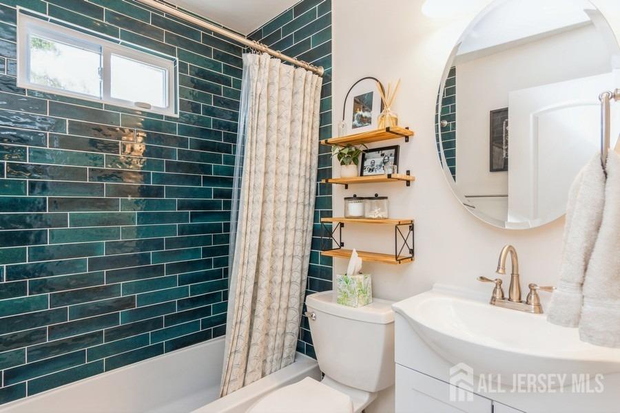 115 Midfield Road Colonia, NJ 07067 - Photo 10 of 25 a bathroom with a sink a toilet and shower