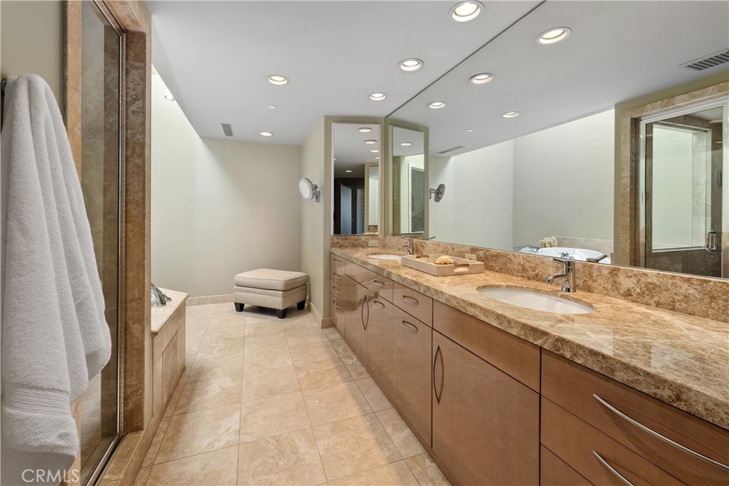 6533 Lago Lindo Rancho Santa Fe, CA 92067 - Photo 30 of 57 a bathroom with a double vanity sink and mirror