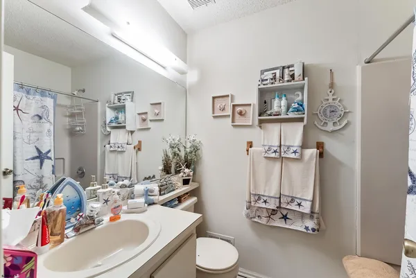 a bathroom with a sink mirror and toilet