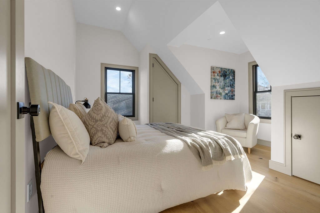 151 Mason Terrace, Unit 2 Brookline, MA 02446 - Photo 19 of 21 a bedroom with a bed and a painting