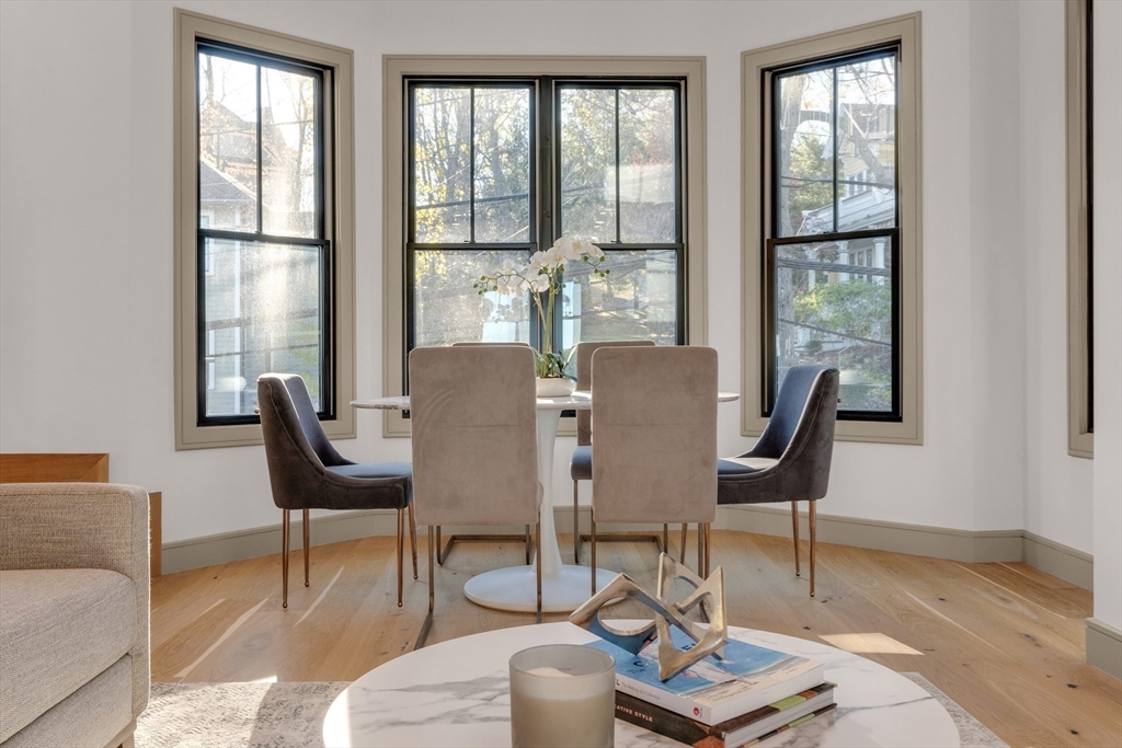 151 Mason Terrace, Unit 2 Brookline, MA 02446 - Photo 5 of 21 a view of a dining room with furniture wooden floor and a potted plant