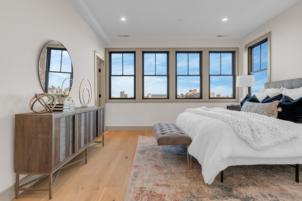 151 Mason Terrace, Unit 2 Brookline, MA 02446 - Photo 10 of 21 a spacious bedroom with a large bed and a large window