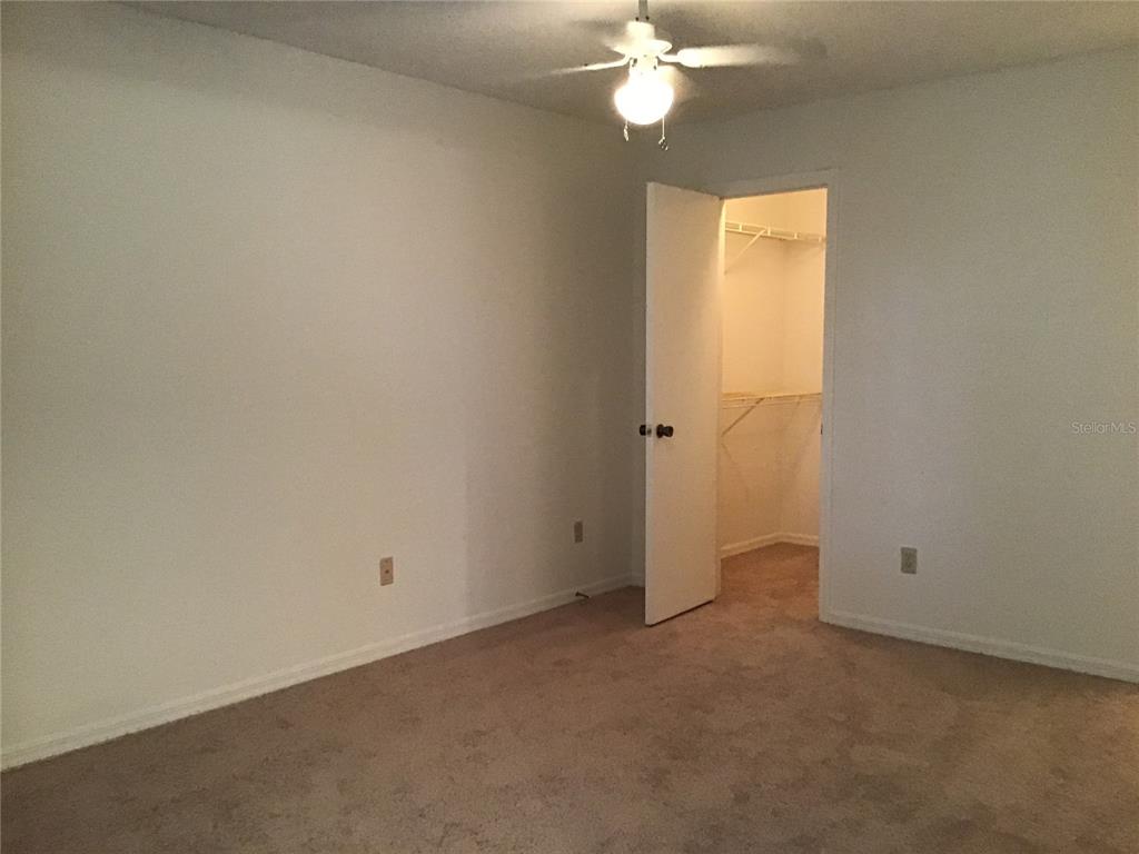 1029 South Hiawassee Road, Unit 2412 Orlando, FL 32835 - Photo 11 of 20 an empty room with a chandelier fan