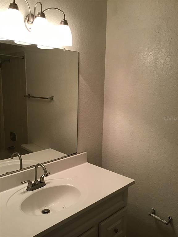 1029 South Hiawassee Road, Unit 2412 Orlando, FL 32835 - Photo 14 of 20 a bathroom with a sink vanity and a mirror