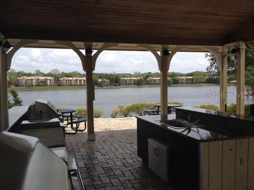 1029 South Hiawassee Road, Unit 2412 Orlando, FL 32835 - Photo 20 of 20 a view of a lake with couches in patio