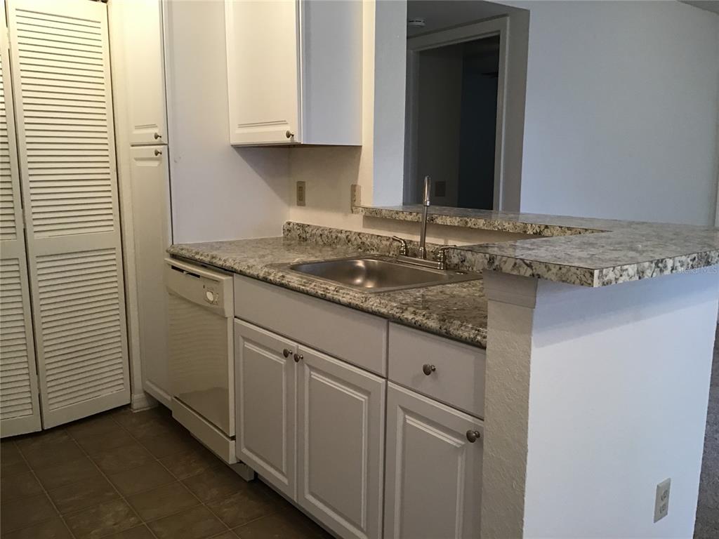 1029 South Hiawassee Road, Unit 2412 Orlando, FL 32835 - Photo 6 of 20 a bathroom with a granite countertop sink and a mirror