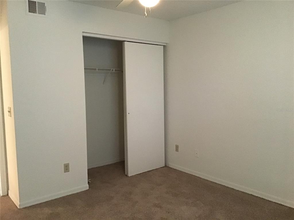 1029 South Hiawassee Road, Unit 2412 Orlando, FL 32835 - Photo 9 of 20 an empty room with a ceiling fan