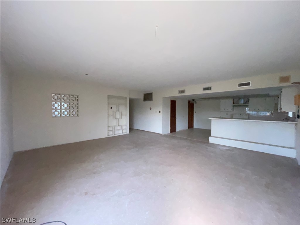 1107 Patterson Road Cape Coral, FL 33909 - Photo 3 of 35 a view of empty room with a fireplace