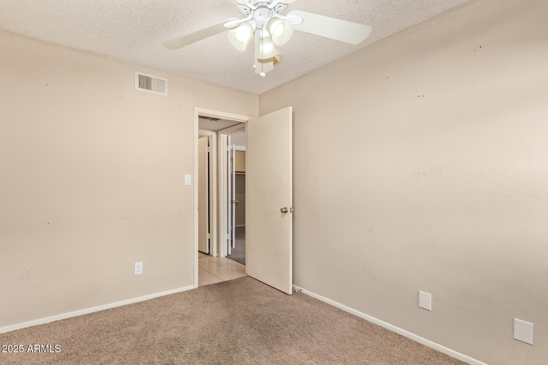 917 South Acapulco Lane, Unit C Tempe, AZ 85288 - Photo 18 of 21 an empty room with a chandelier fan and closet area