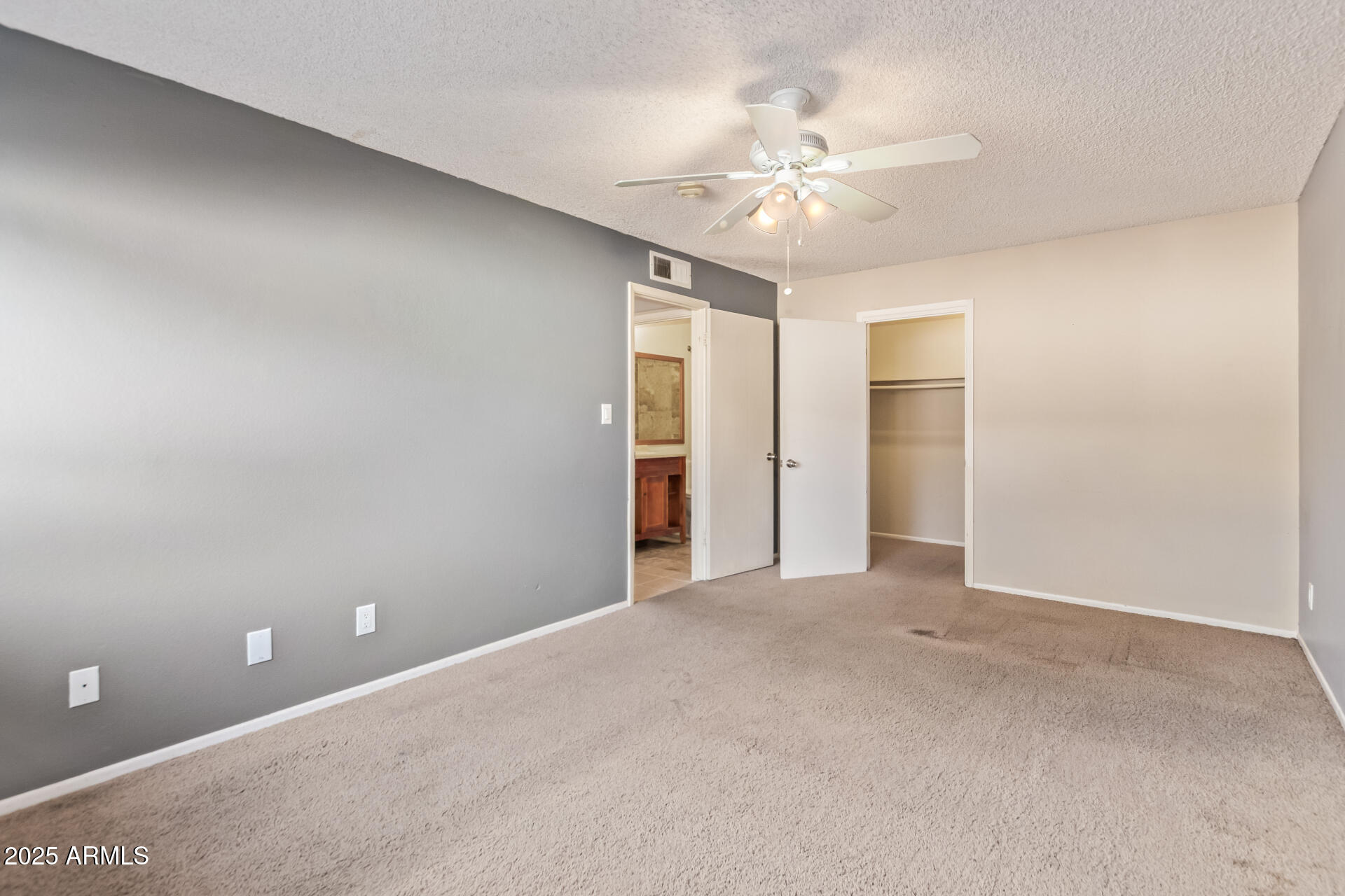 917 South Acapulco Lane, Unit C Tempe, AZ 85288 - Photo 5 of 21 a view of an empty room with a chandelier fan