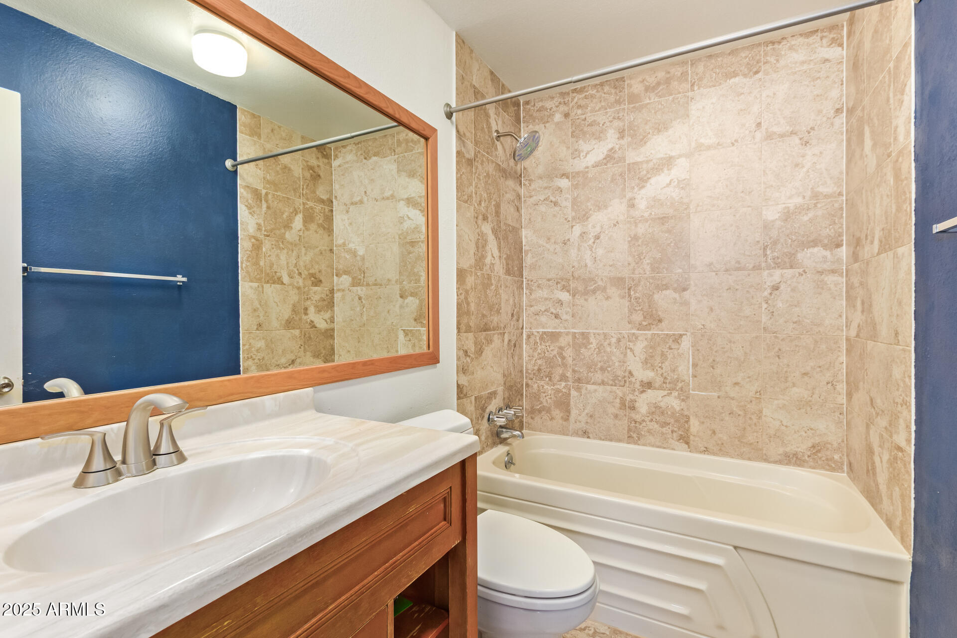 917 South Acapulco Lane, Unit C Tempe, AZ 85288 - Photo 6 of 21 a bathroom with a granite countertop sink and a mirror