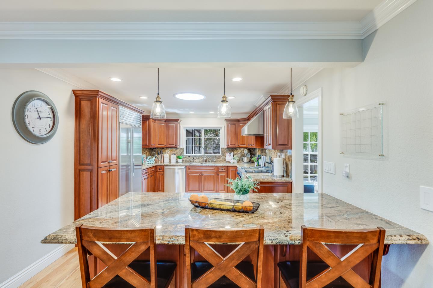 1570 Walnut Drive Campbell, CA 95008 - Photo 20 of 68 a room with stainless steel appliances kitchen island granite countertop a dining table chairs and a refrigerator