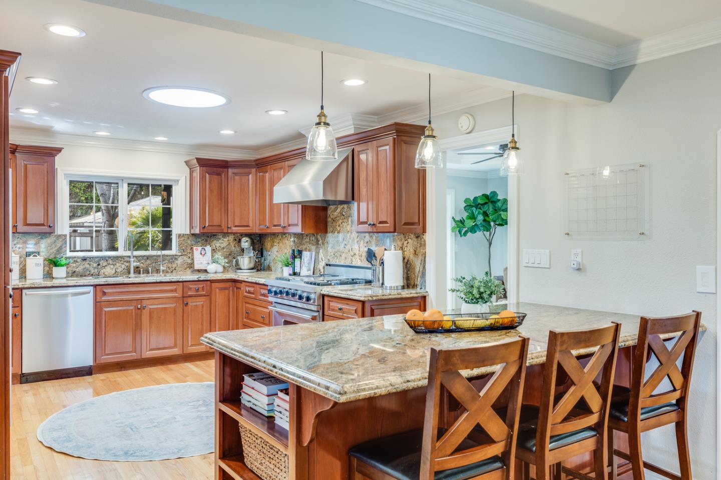 1570 Walnut Drive Campbell, CA 95008 - Photo 22 of 68 a kitchen with stainless steel appliances granite countertop a kitchen island a stove a table and chairs in it