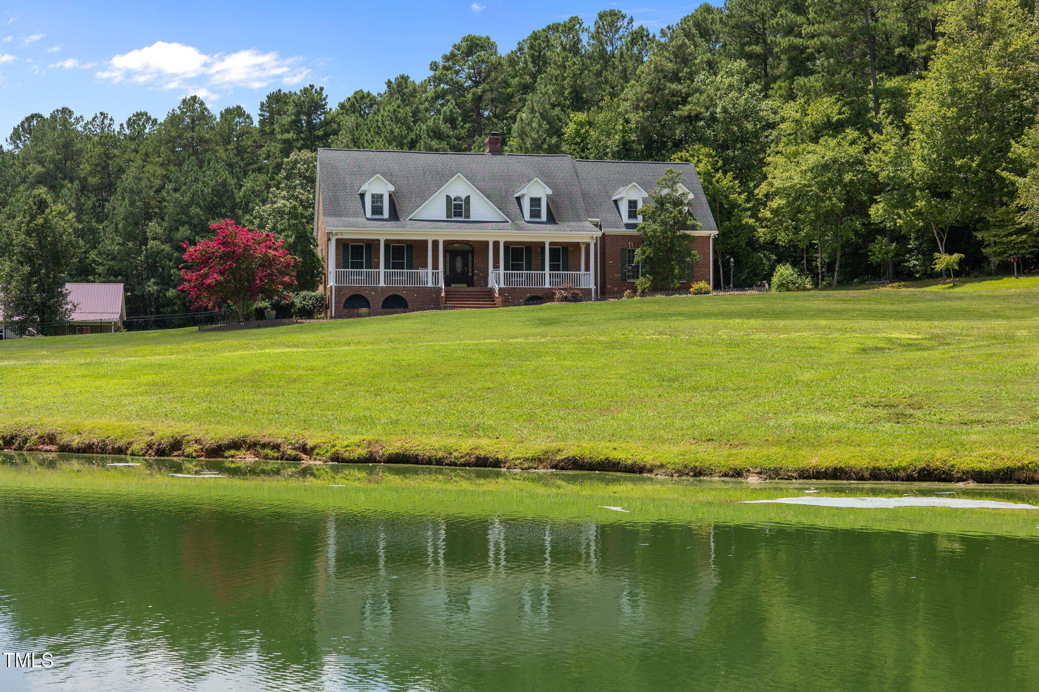 5405 Carbonton Road Sanford, NC 27330 - Photo 1 of 63 a front view of a house with a garden