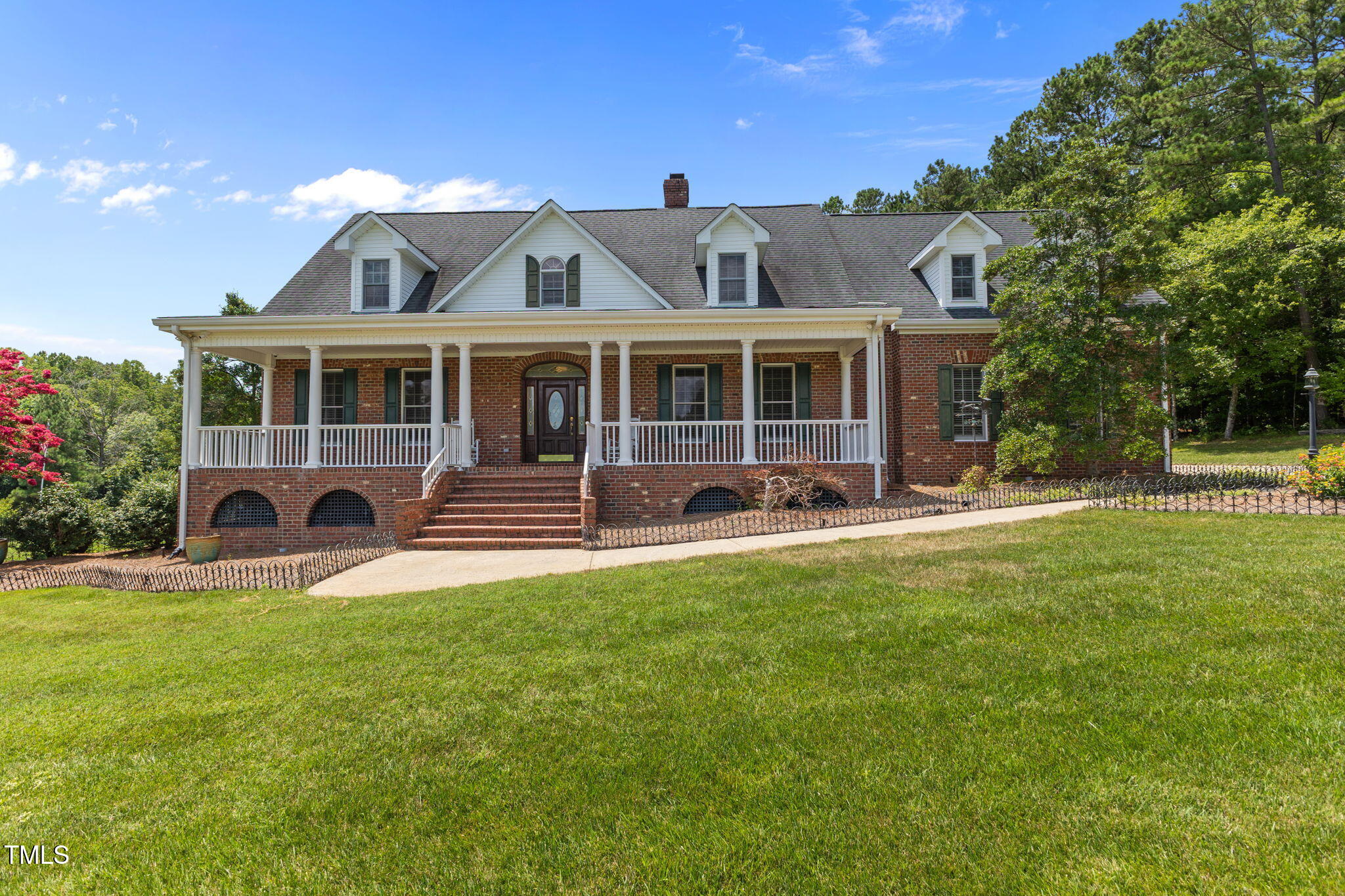 5405 Carbonton Road Sanford, NC 27330 - Photo 2 of 63 a front view of a house with yard and green space