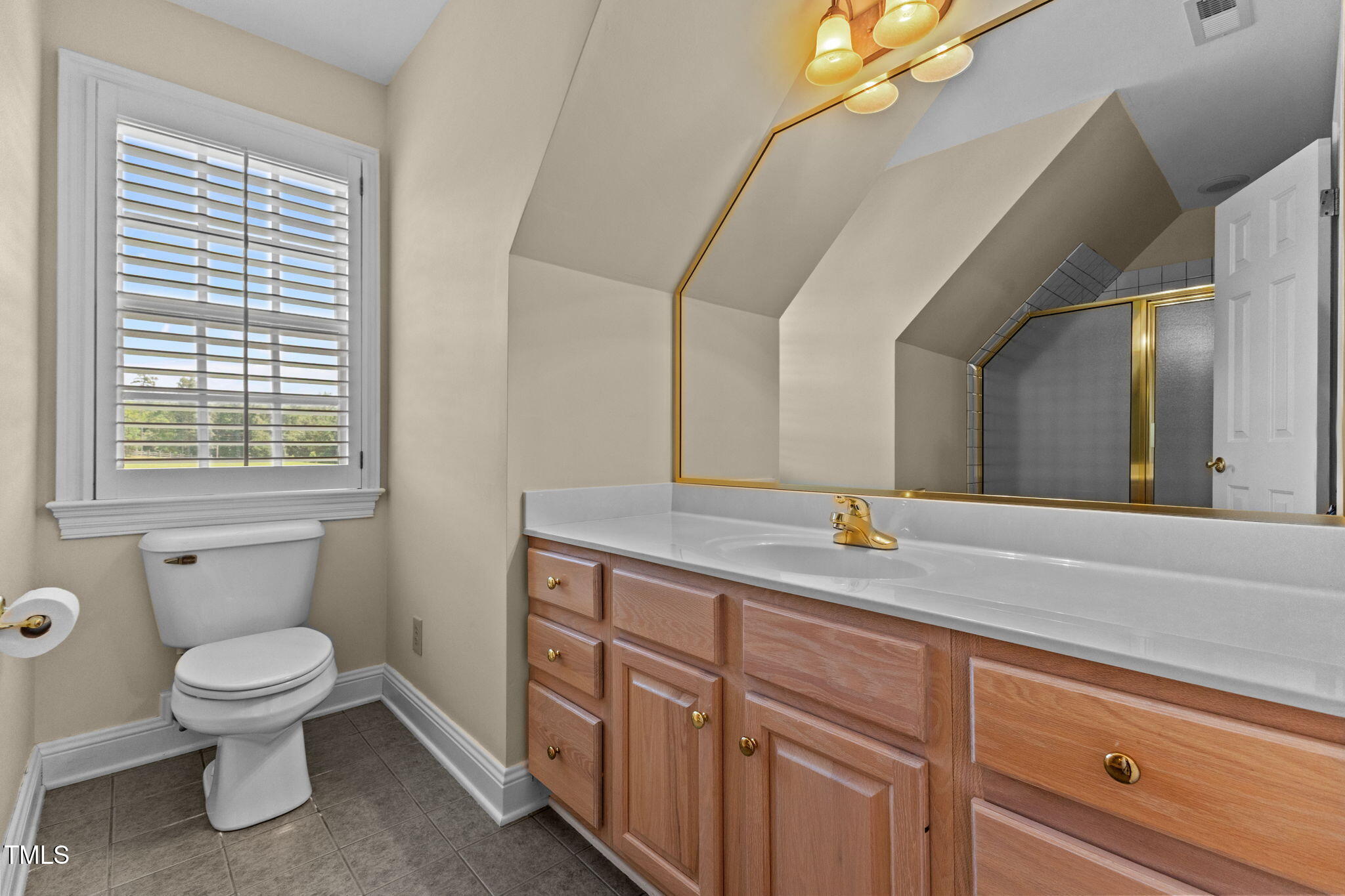 5405 Carbonton Road Sanford, NC 27330 - Photo 30 of 63 a spacious bathroom with a granite countertop sink a toilet and a mirror