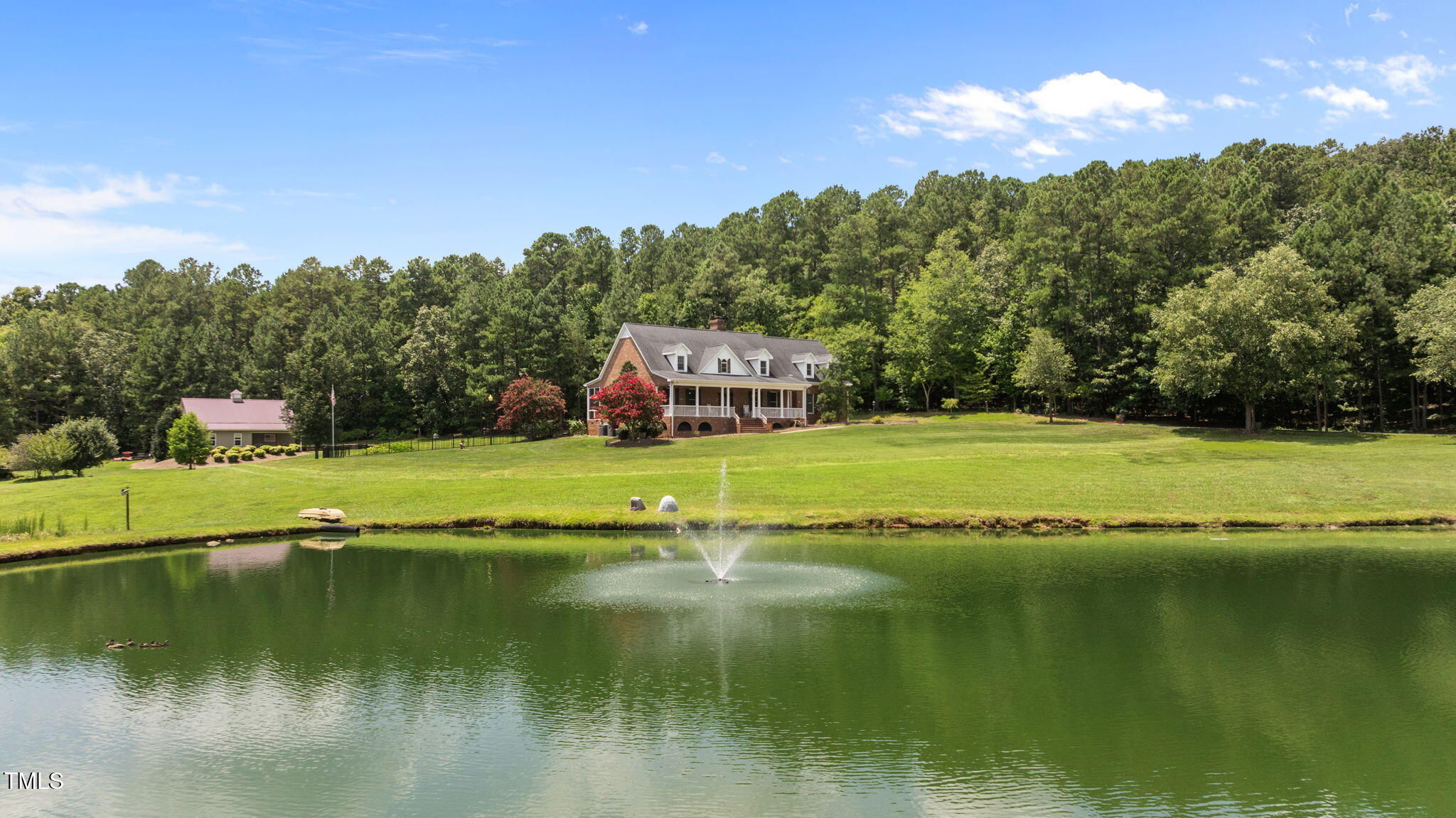 5405 Carbonton Road Sanford, NC 27330 - Photo 56 of 63 a view of a lake with houses in the background