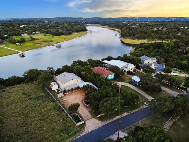 an aerial view of a house with a lake view