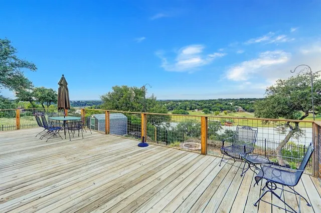 a view of a balcony with chair and wooden floor