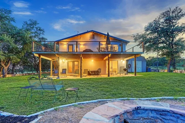 a kitchen with kitchen island a appliances dining table and chairs