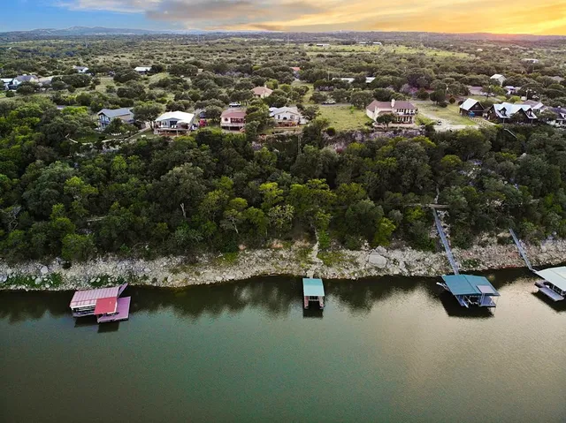 an aerial view of residential houses with lake view