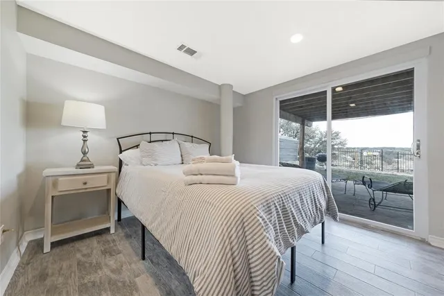 a view of a house with a big yard and a large trees