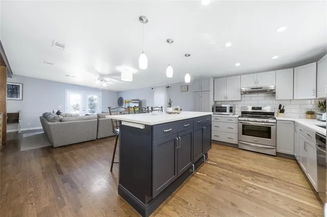 a view of a house with a big yard and large trees