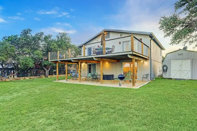 a roof deck with table and chairs a barbeque with wooden floor and fence