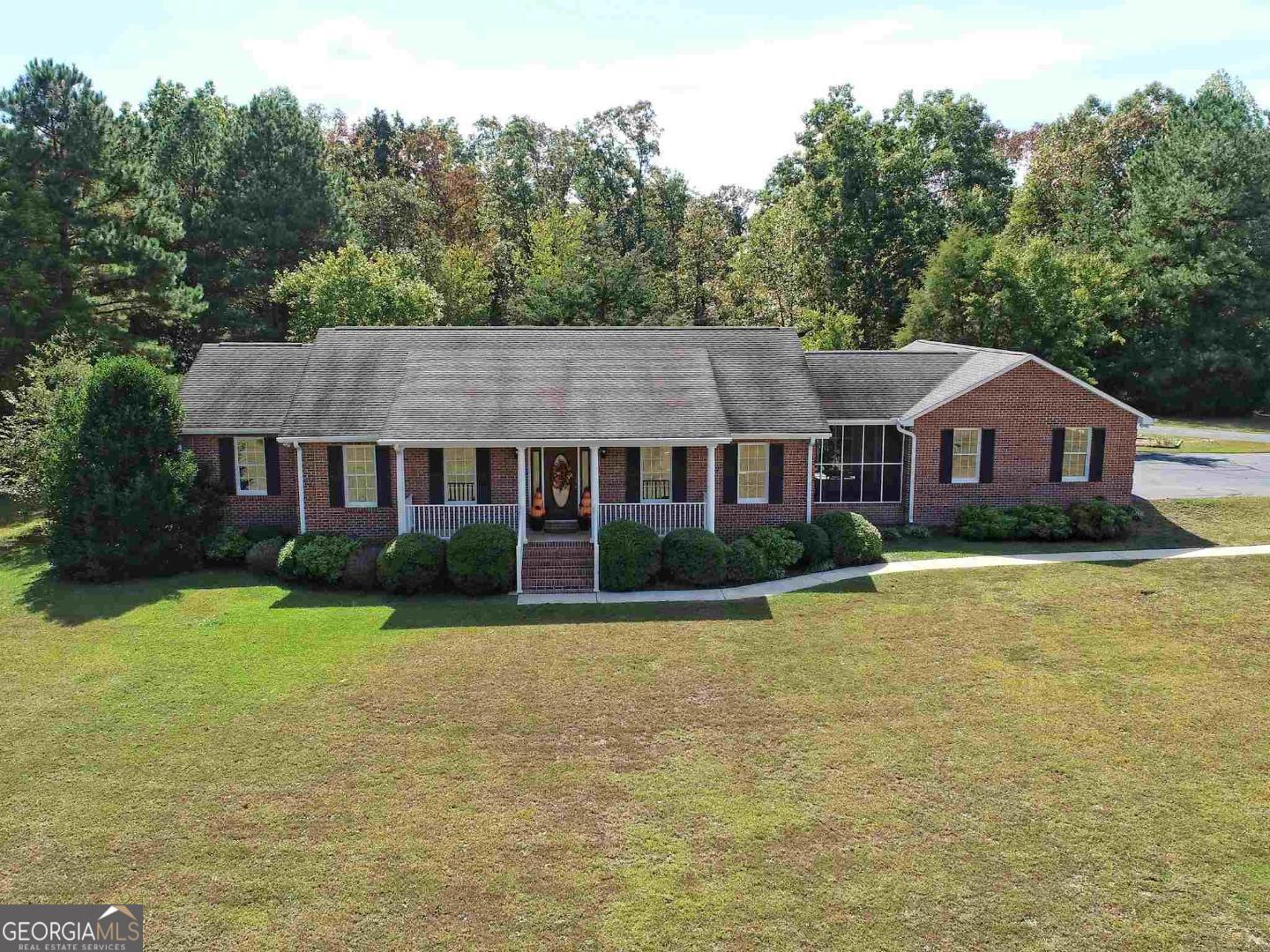 2977 Deep Creek Road Bowman, GA 30624 - Photo 1 of 1 a aerial view of a house next to a big yard and large trees