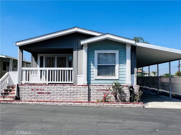 a view of a house with wooden fence