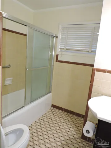 a bathroom with a sink toilet and shower