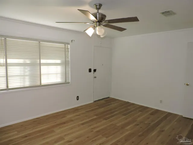 wooden floor in an empty room with a window