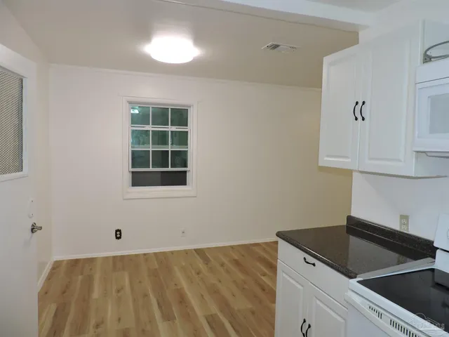 a kitchen with a sink cabinets and a window