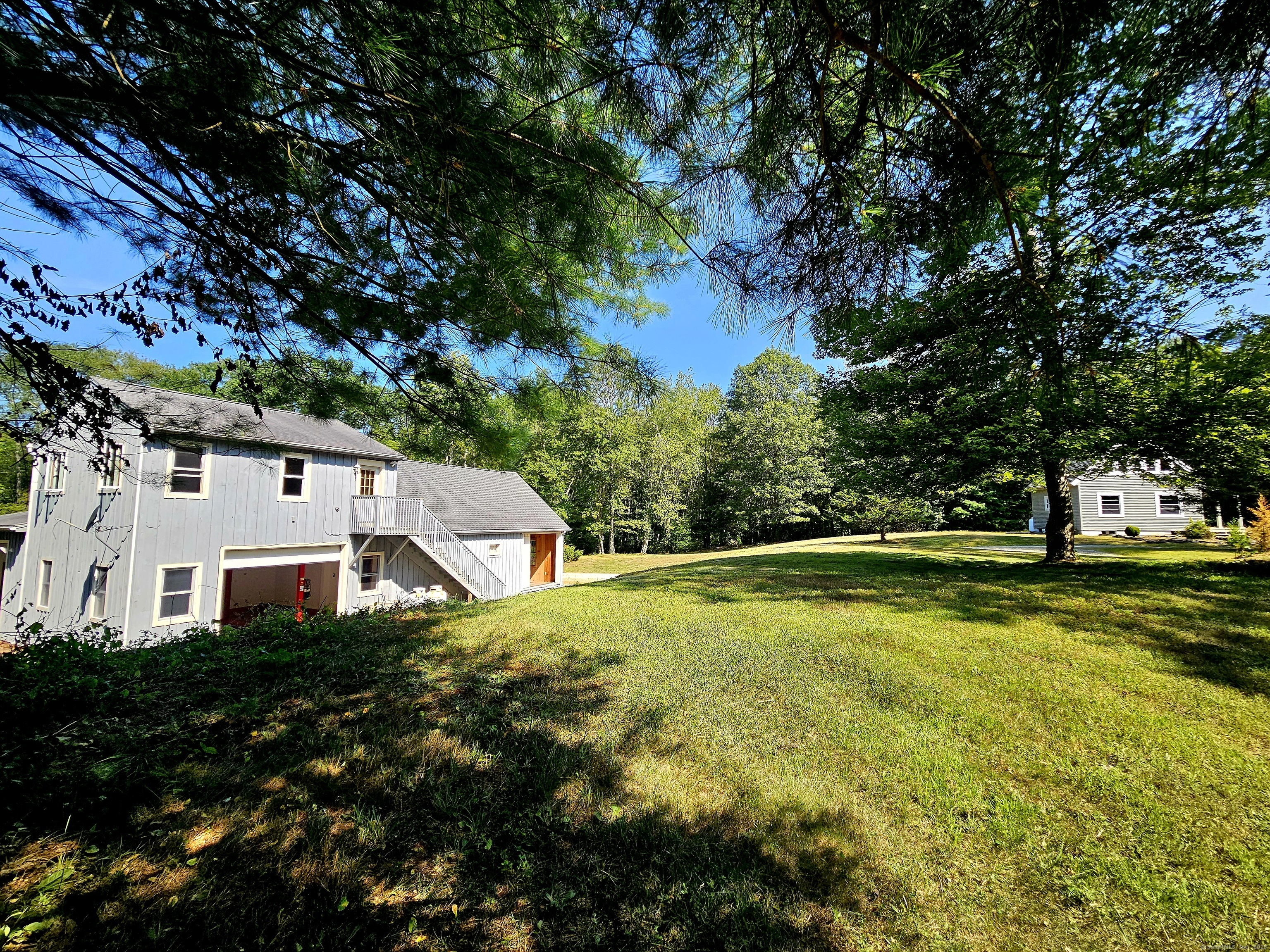 a view of a house with pool and a yard