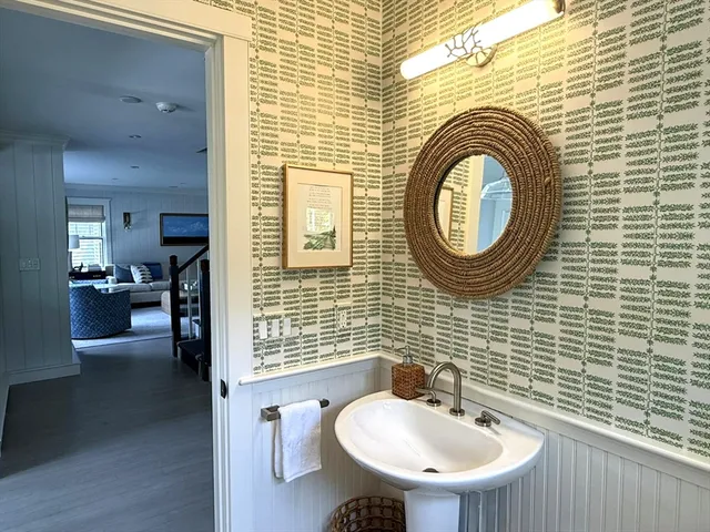 a bathroom with a sink a mirror and a shower