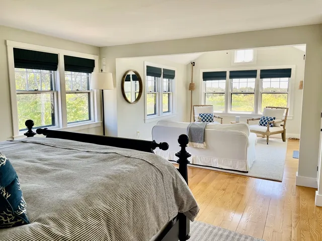 a bedroom with a large bed and a large window