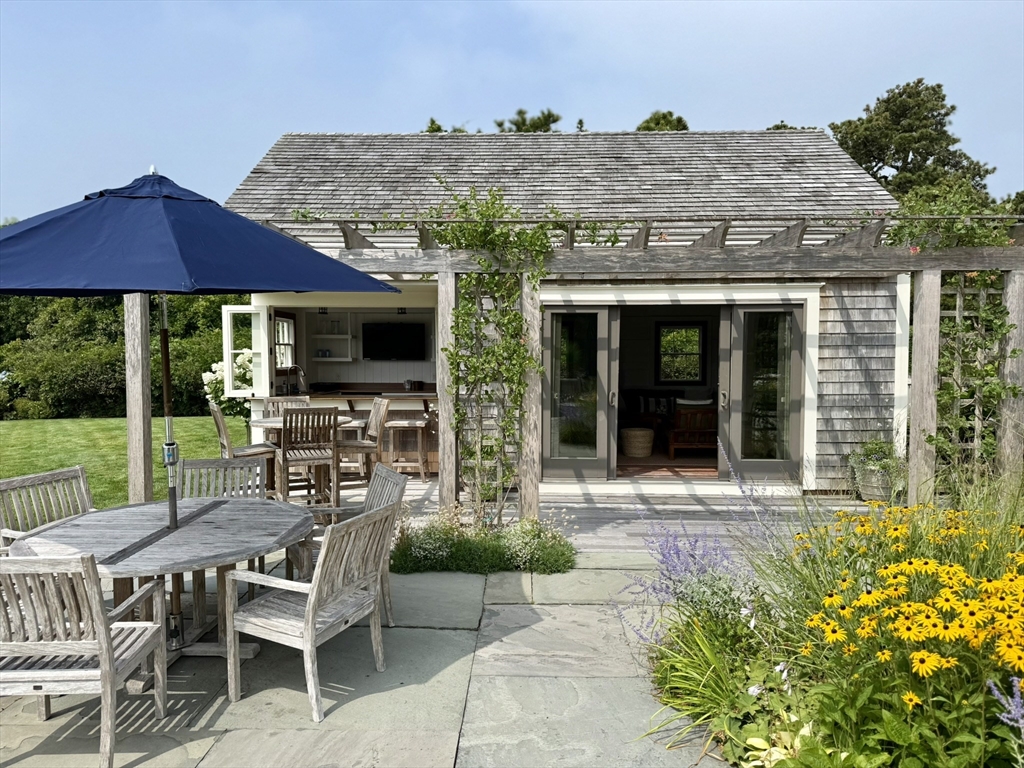1 Pochick Avenue Nantucket, MA 02554 - Photo 34 of 42 a view of a house with backyard sitting area and garden