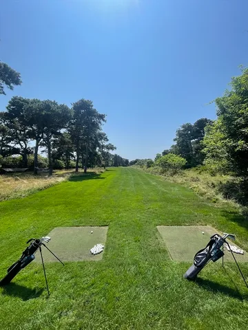 a view of a house with a big yard and large trees
