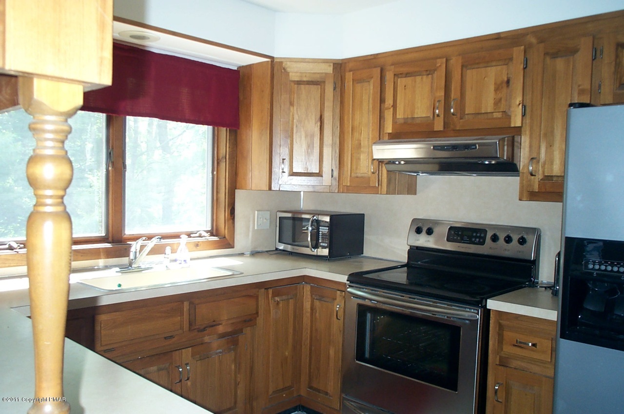 635 Decker Road Bushkill, PA 18324 - Photo 2 of 9 a kitchen with a stove a sink and a microwave