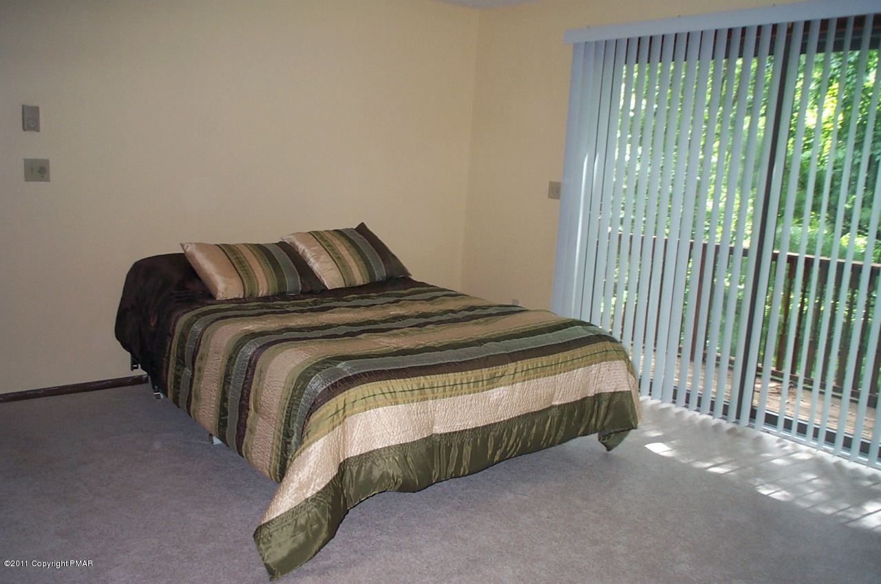 635 Decker Road Bushkill, PA 18324 - Photo 6 of 9 a bed sitting in a bedroom next to a window