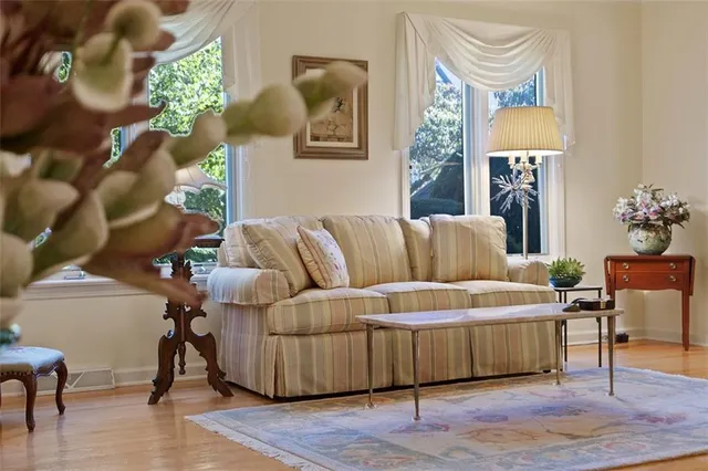 a living room with furniture and a lamp